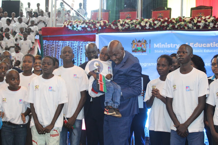 Education Cabinet Secretary Ezekiel Machogu with learners during the launch of the 2024 Elimu scholarship program at the Bomas of Kenya, Nairobi on January 19, 2023