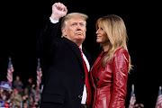 US President Donald Trump gestures next to first lady Melania Trump after speaking at a campaign event for Republican US senators David Perdue and Kelly Loeffler in Valdosta, Georgia, US, on December 5 2020. 