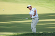 Collin Morikawa of the United States plays a shot onto the ninth green during the second round of the 122nd U.S. Open Championship at The Country Club on June 17, 2022 in Brookline, Massachusetts. 