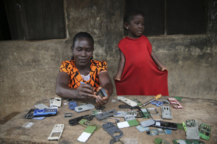 For some, the mobile phone revolution has produced new work opportunities. Image: Akintunde Akinleye/Reuters