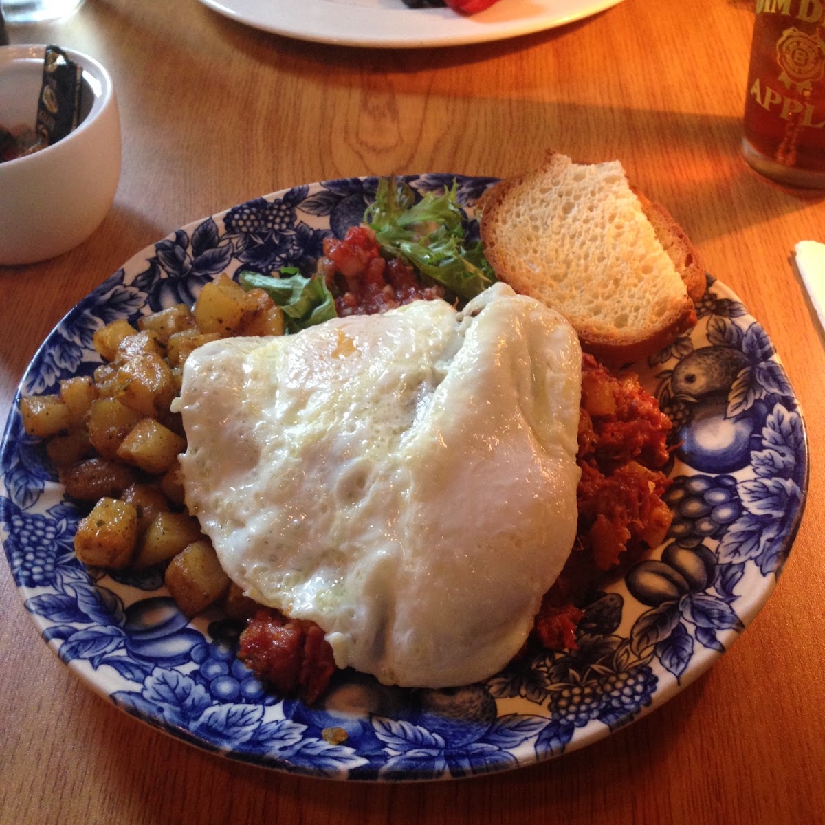 Home fries, corn beef hash, fried eggs and GF bread.