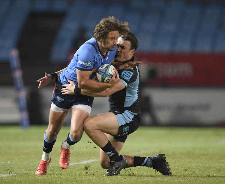 Bulls player James Verity Amm tries to evade a tackle from Cole Forbes of Glasgow Warriors during their United Rugby Championship match at Loftus Versfeld Stadium on the 29 April 2022 .