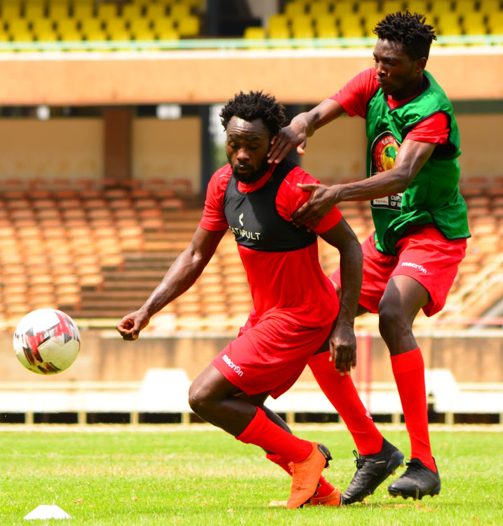 Collins Sichenje (R) and Elvis Rupia fight for the ball in a past Harambee Stars training session at Moi Stadium, Kasarani