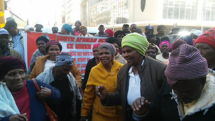 Families of the silicosis victims sing outside the South Gauteng High Court where a settlement with certain mining companies was presented.