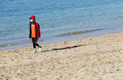 A girl walks on the Arrecife beach amid the coronavirus disease outbreak on the island of Lanzarote, Spain, on May 3 2020. 