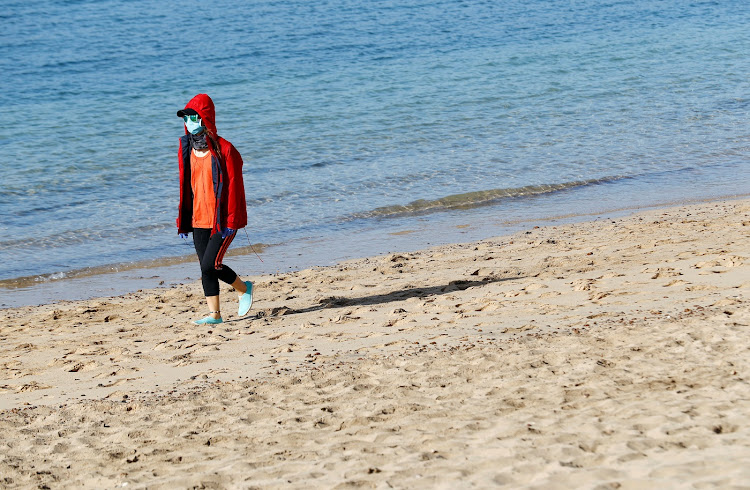 A girl walks on the Arrecife beach amid the coronavirus disease outbreak on the island of Lanzarote, Spain, on May 3 2020.