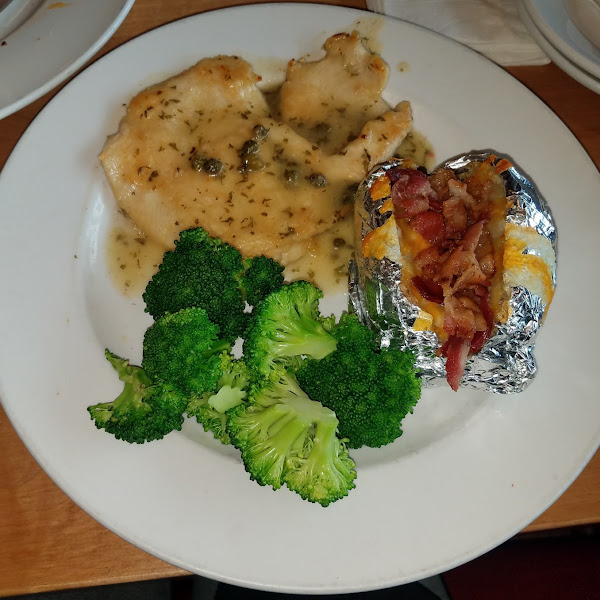 Chicken piccata with broccoli and baked potato