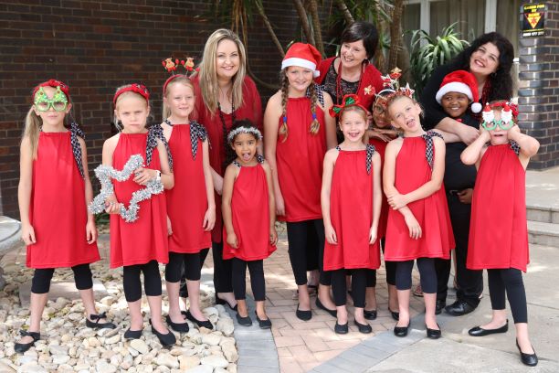 BIG VOICES: Director Ulagh Williams, Eastern Cape Junior Children’s Choir conductor Hanlie Young and accompanist Lilian Zeelie with some of the children who will take part in 'A Jazzy Christmas'