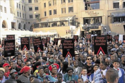 SONG FOR MADIBA: The crowd during the recording of the 'Happy Birthday' song for Mandela at the Nelson Mandela Square precinct in Sandton yesterday. Photo: Busi Mbatha