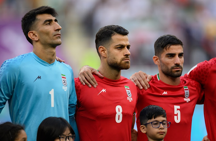 (Left to right) Iran players Alireza Beiranvand, Morteza Pouraliganji and Morteza Pouraliganji line up for the national anthem prior to their Fifa World Cup Qatar 2022 Group B match against England at Khalifa International Stadium on November 21 2022.