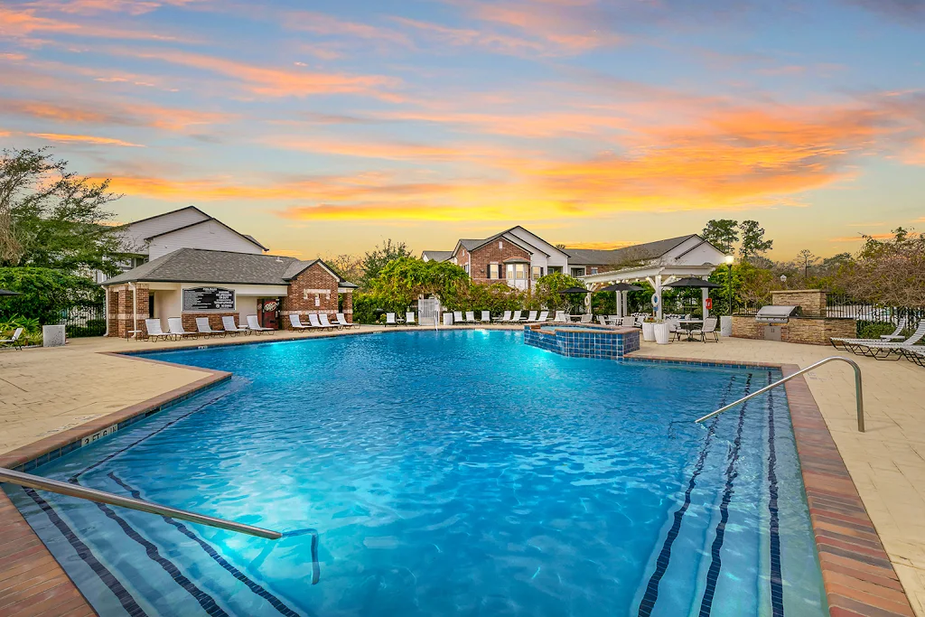 Villas at Cypresswood Apartments sparkling community pool at dusk