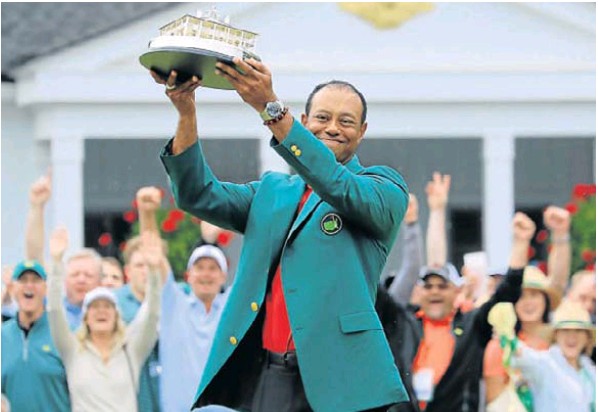 Tiger Woods wears the Green Jacket and holds the Masters Trophy after winning the 2019 Masters Tournament at the Augusta National Golf Club in April