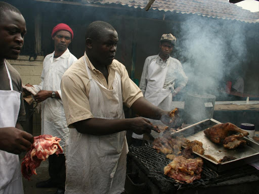 People roast meat at Burma market. FILE