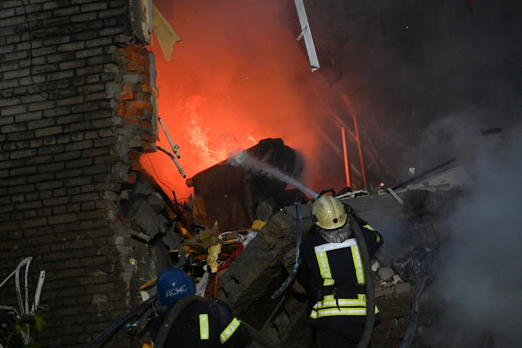 Rescuers work at a site of a residential building heavily damaged by a Russian missile strike, amid Russia's attack on Ukraine, in Zaporizhzhia, Ukraine October 10, 2022.