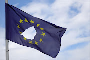 An EU flag, with a hole cut in the middle, flies at half-mast outside a home in Knutsford, Cheshire, after the historic referendum this week. EU leaders are pushing for Brexit to start sooner rather than later.