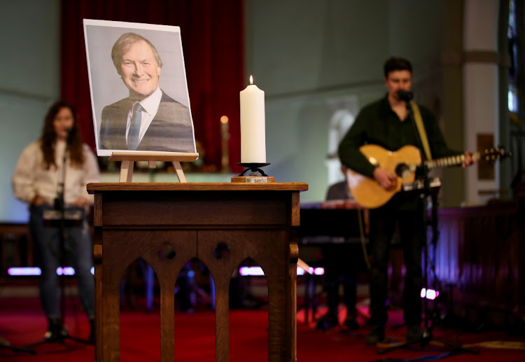 A candle and a portrait of British MP David Amess, who was stabbed to death during a meeting with constituents, are seen at the church of St Michael's and all Angels, in Leigh-on-Sea, Britain, October 17, 2021.