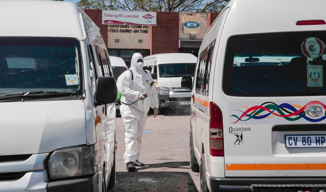 One of the Outsurance points-men wearing personal protective equipment at the Esangweni Taxi Rank, Tembisa where taxis were disinfected on April 6 2020.