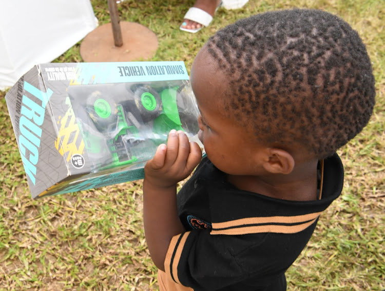 A little boy inspects a gift from KwaZulu-Natal premier Nomusa Dube-Ncube.