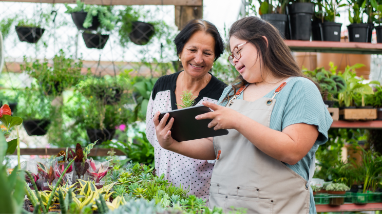 Colleagues looking at a tablet in a plant shop