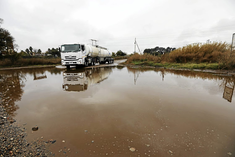 A flooded road leads up to the Clover cheese factory in the North West town of Lichtenburg. The Road Freight Association says roads like these are extremely important to the country. File photo.