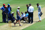 Umpire, Lubabalo Gcuma and Umpire, Dennis Smith look at the pitch during day 1 of the Sunfoil Series match between Multiply Titans and BuildNAT Cape Cobras at SuperSport Park on January 26, 2017 in Pretoria, South Africa.