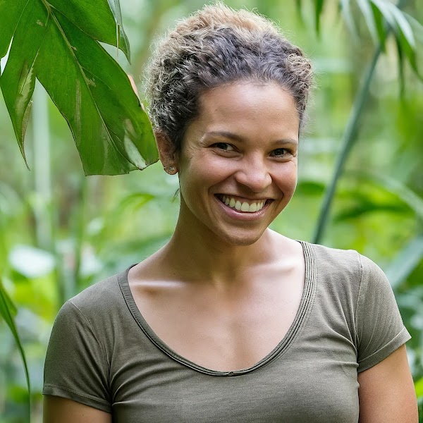 Shot of 32-year-old female conservationist in the forest;  Athletic with short, curly hair and a warm smile