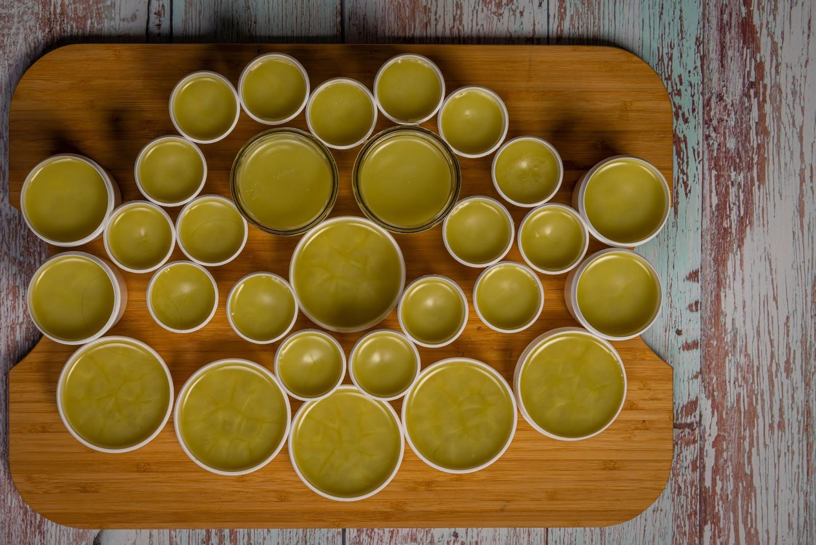 overhead view of jars of CBD salve sitting on a wooden table