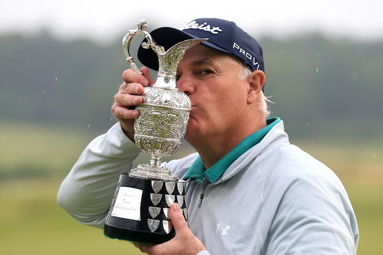 Stephen Dodd of Wales celebrates victory with the trophy during day four of The Senior Open at Sunningdale Golf Club on July 25, 2021