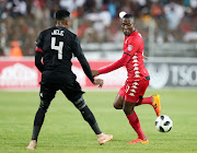 Tendai Ndoro of Highlands Park is challenged by Orlando Pirates captain Happy Jele during the Absa Premiership matchat the Makhulong Stadium in Tembisa on January 8 2019.