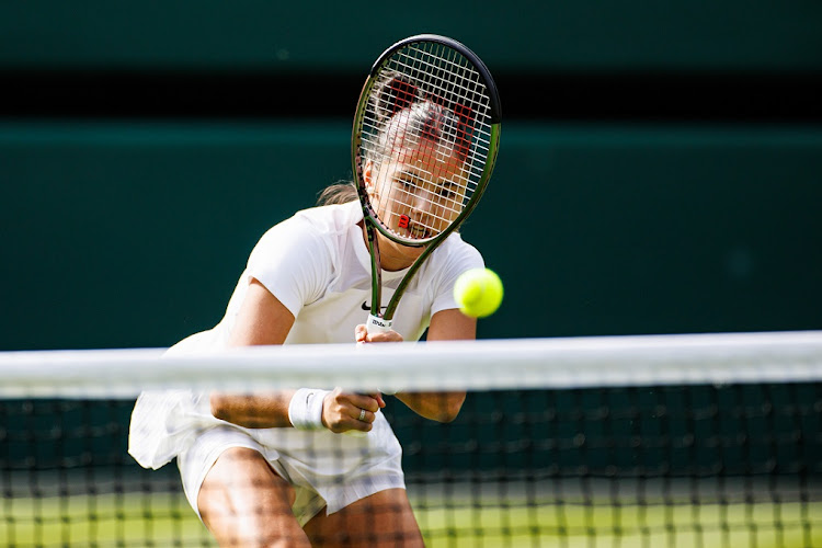 Emma Raducanu of Great Britain hits a backhand against Alison Van Uytvanck of Belgium on day one of The Championships Wimbledon 2022 at the All England Lawn Tennis and Croquet Club in London on June 27 2022.