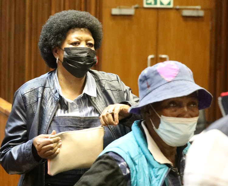 Cordelia Velaphi Mogoerane, in a black mask, and co-accused Ntobizodwa Dlamini. It is alleged Mogoerane arranged for hitmen to murder her husband, retired crime intelligence officer Thekiso Hendrick Mogoerane.