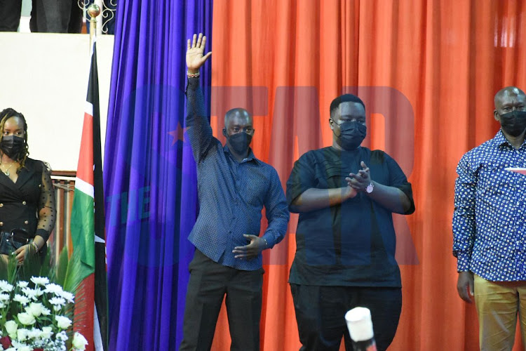 Agnes Kagure's brother waves to the crowd during the official launch her campaign at Kasarani Indoor Arena on January 7, 2022.