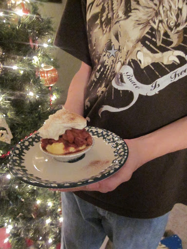 My grandson holding our Christmas Eve Mini Pear Tart.