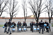 Police is seen near San Vittore Prison during a revolt by inmates after family visits were suspended due to fears over coronavirus contagion, in Milan, Italy March 9, 2020.  
