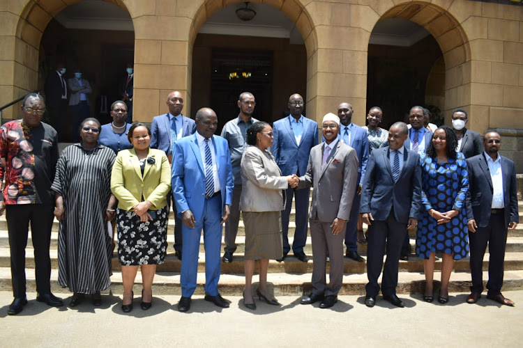 Chief Justice Martha Koome congratulations newly sworn in IEBC CEO Marjan Hussein in the presence of Commissioners at the Supreme Court on March 16, 2022