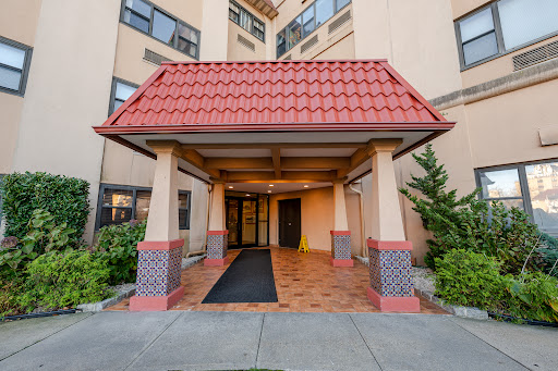 Building entrance with red awning in this luxury apartment / penthouse for sale in Long Beach ($659,000)