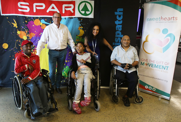 Purchasing manager for Spar Eastern Cape Alan Stapleton and Daily Dispatch marketing manager Jennilee Peremore-Oliver pose with Spar Daily Dispatch Summer Fun Run beneficiaries Angelo Walker, Litha Soldati and Elroy Fortune, who all received new wheelchairs on Monday.