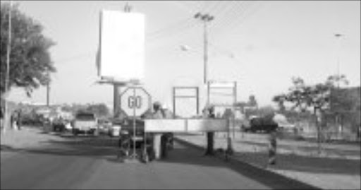 BUSY: Polokwane municipality employees busy beautifying one of the main streets in Seshego. Pic. Ramatsiyi Moholoa. 18/06/07. © Sowetan.