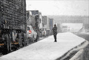 Trucks line up along the N3 on-ramp in Harrismith after snow in the Free State town forced officials to close the major route between Villiers and Van Reenen's Pass. File photo.