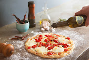 An image of a pizza with SA Olive Seal.