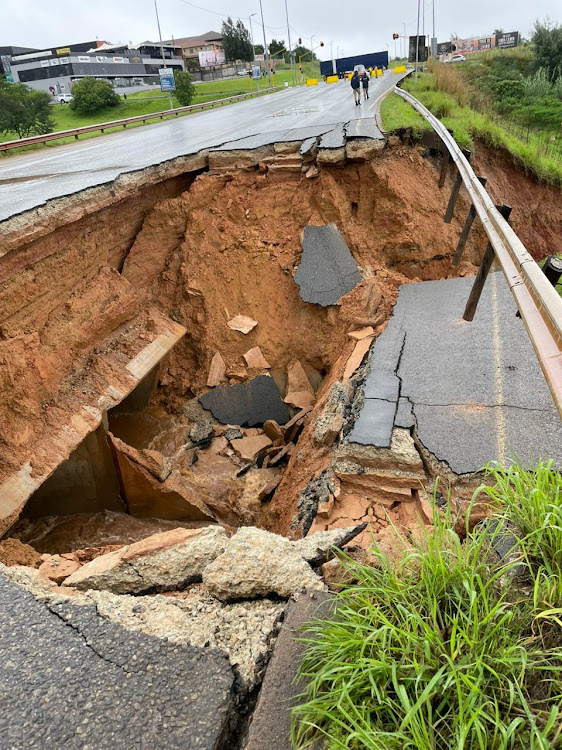 A section of the road at a bridge has collapsed.