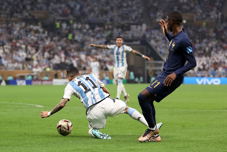 Angel Di Maria of Argentina is fouled by Ousmane Dembélé of France, which leads to a penalty for Argentina in the World Cup final at Lusail Stadium on December 18 2022.