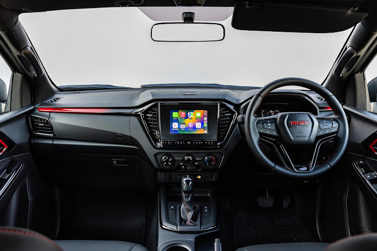 The cabin is enhanced with a red dash divider with the ‘X’ logo, a leather-wrapped and red-stitched steering wheel and red Isuzu badging in the centre. Picture: SUPPLIED