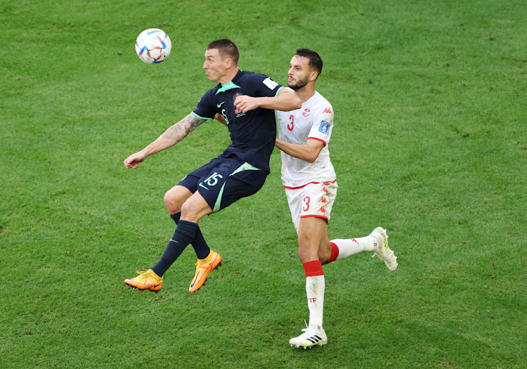 Australia's Mitchell Duke battles for possession with Montassar Talbi of Tunisia during the FIFA World Cup Qatar 2022 Group D match at Al Janoub Stadium on November 26, 2022 in Al Wakrah, Qatar.