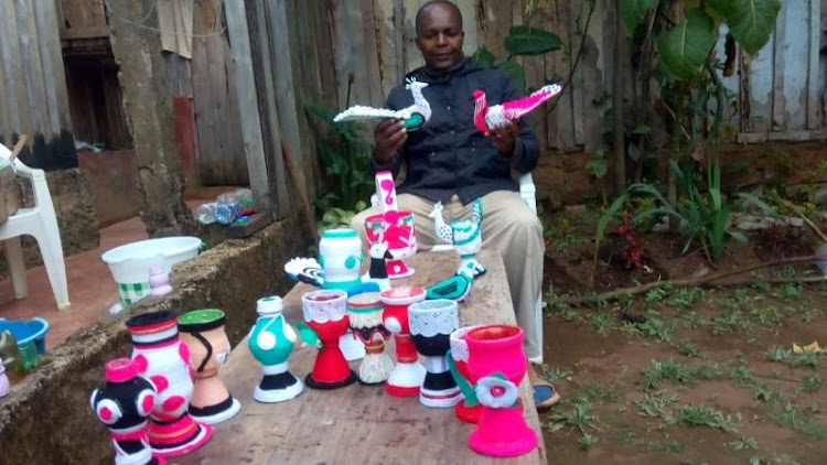 Alexander Mburugu, displays some of the items he has made from plastic waste during Covid-19.