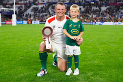 Deon Fourie, with his son, displays his man of the match award after the Springboks' Rugby World Cup pool B win against Tonga at Stade Vélodrome in Marseille on Sunday.