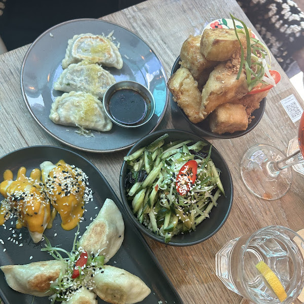 Gluten free dumpling platter (bottom on black plate) and GF tempura aubergine (top in back pot)