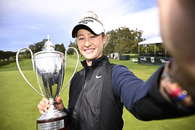 Nelly Korda of the United States imitates a “selfie” as she poses with the trophy following her win in the FIR HILLS SERI PAK Championship at Palos Verdes Golf Club on March 24, 2024 in Palos Verdes Estates, California