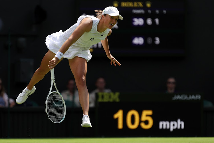 Iga Swiatek of Poland serves against Jana Fett of Croatia in their first round match at The Championships Wimbledon 2022 on June 28 2022.