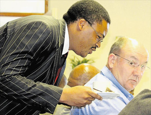 HAVA CUPPA: MEC Mlibo Qoboshiyane gives DA MPL Athol Trollip a cup of Magwa tea at the Bhisho Legislature during the rural development and agrarian reform portfolio committee meeting Picture: SUPPLIED